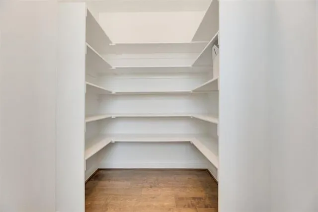 a large kitchen with kitchen island a stove a sink a center island and windows