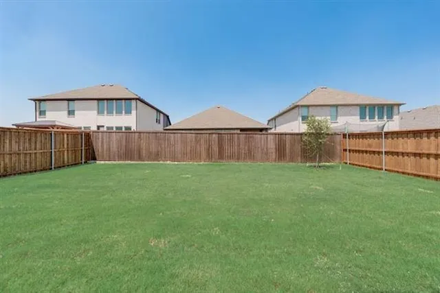 a view of a house with a yard and sitting area