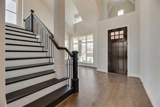 a view of entryway with wooden floor and stairs