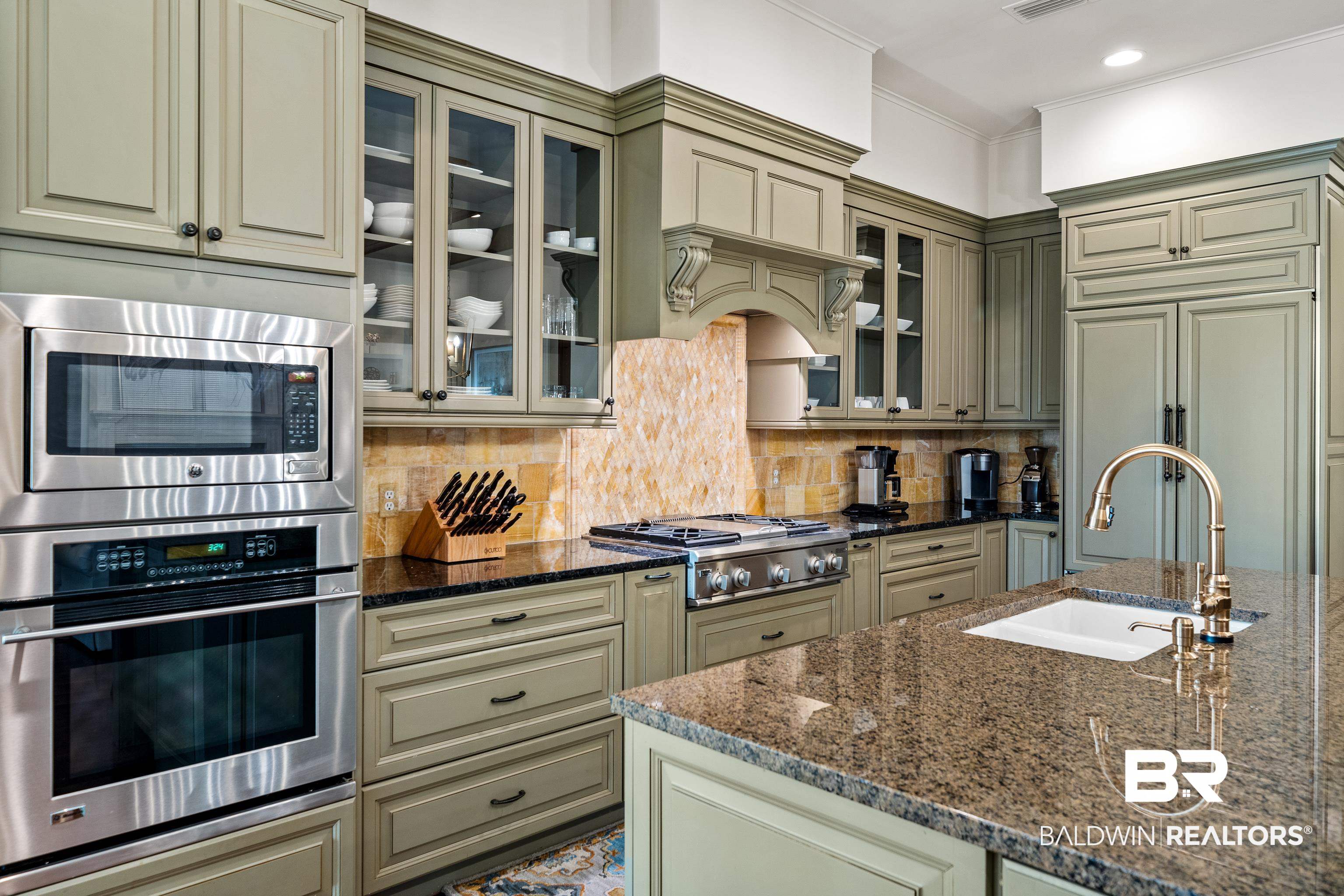 3613 Old Park Road Gulf Shores, AL 36542 - Photo 20 of 72 Kitchen featuring built in appliances, a sink, backsplash, dark stone countertops, and glass insert cabinets