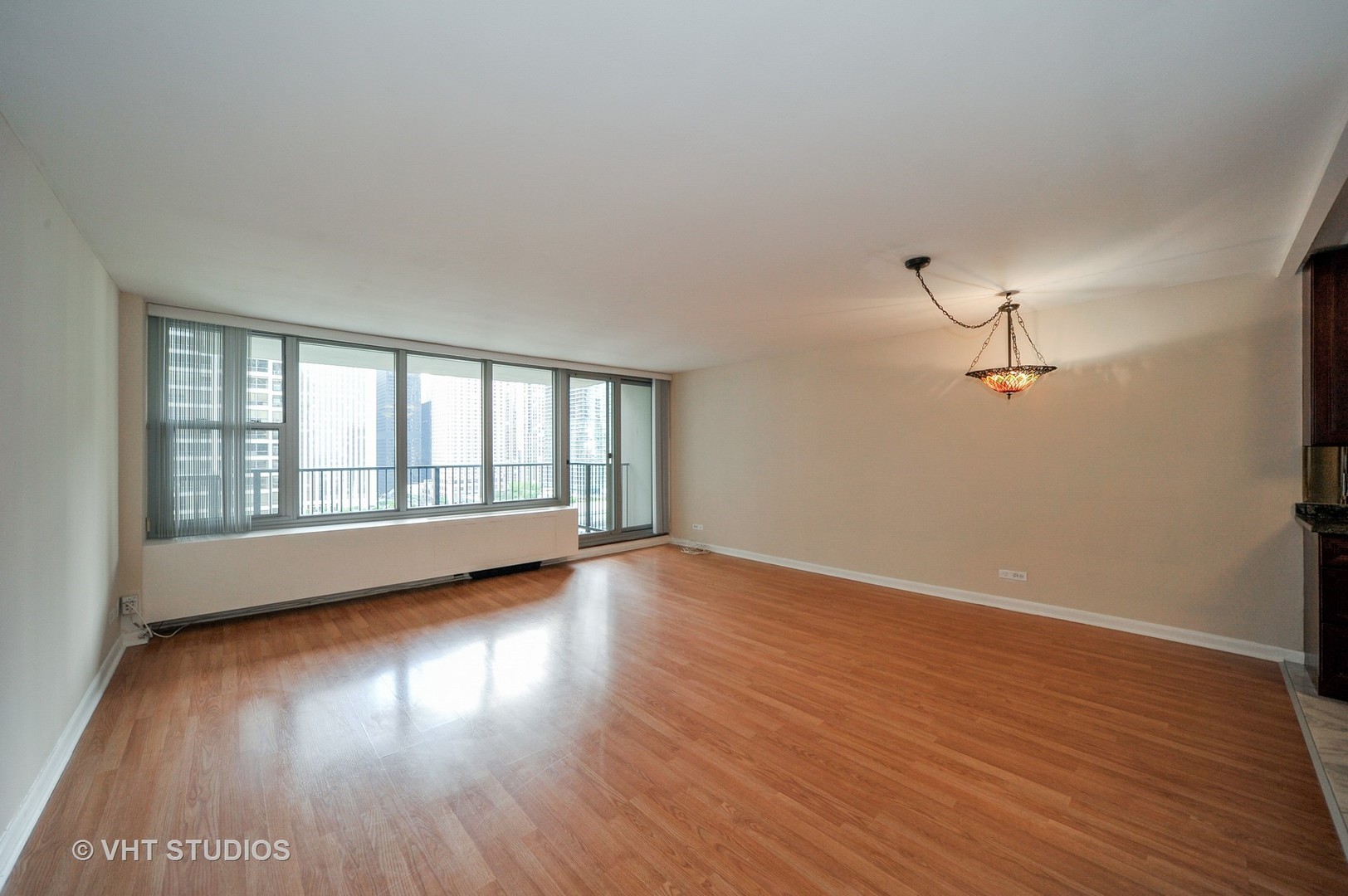 400 East Randolph Street, Unit 1924 Chicago, IL 60601 - Photo 2 of 18 a view of empty room with wooden floor and fan