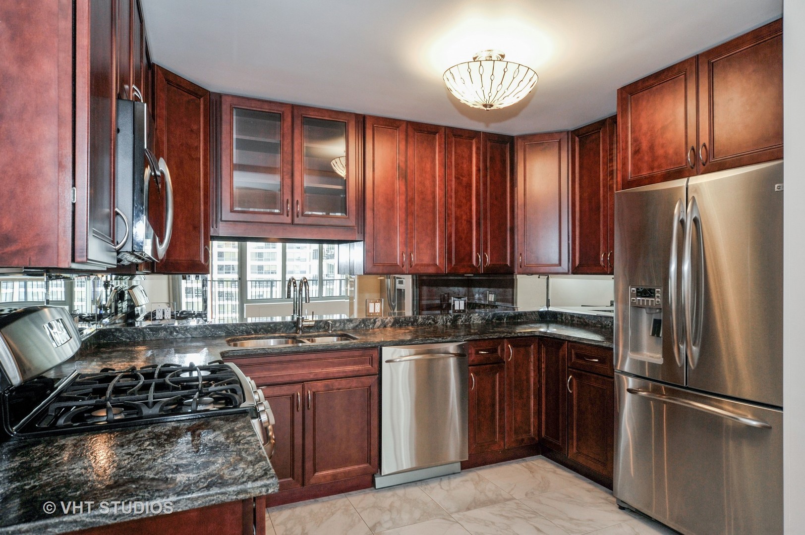 400 East Randolph Street, Unit 1924 Chicago, IL 60601 - Photo 5 of 18 a kitchen with a refrigerator a sink and cabinets