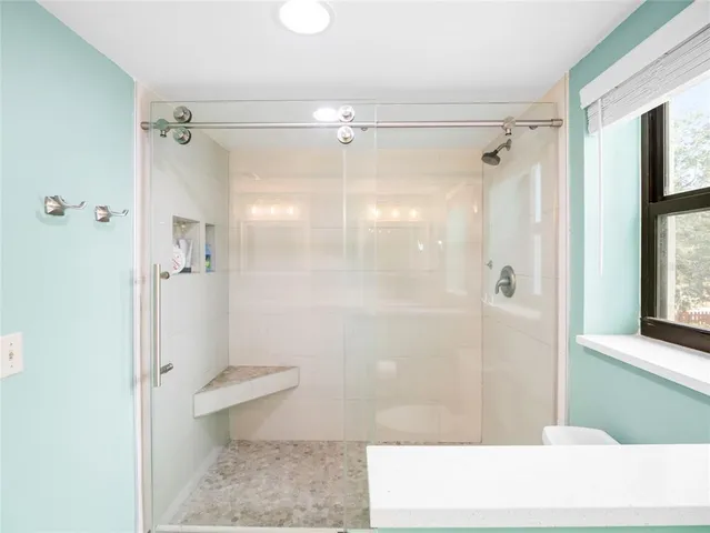 a bathroom with a shower and a toilet