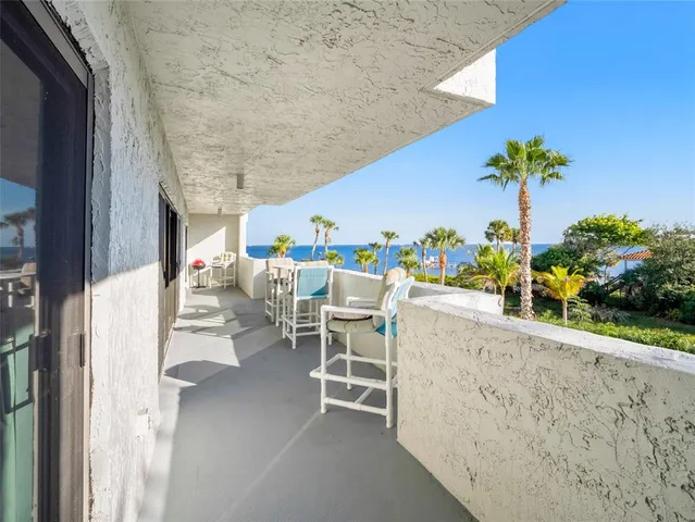 a dining room with furniture and a potted plant