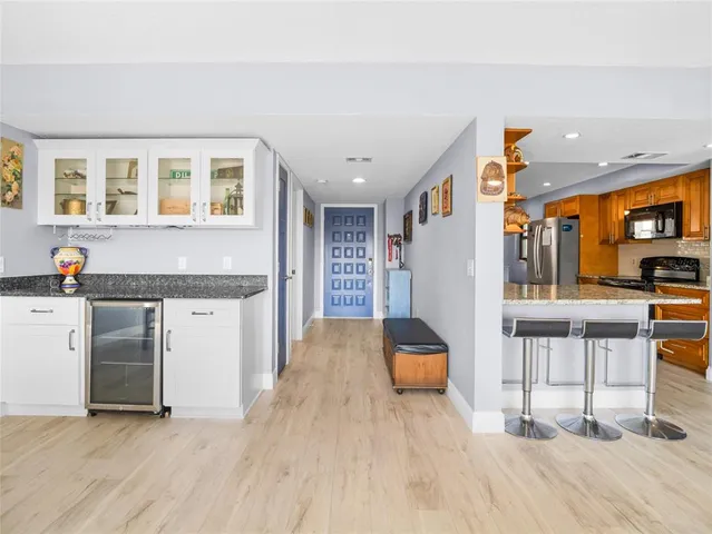 a open kitchen with stainless steel appliances granite countertop a stove and a refrigerator