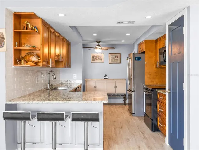 a kitchen with a sink appliances and cabinets