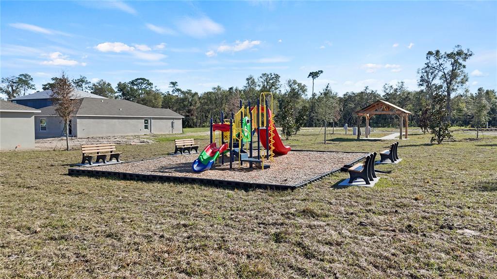 1394 Inkberry Circle DeLand, FL 32720 - Photo 25 of 26 a view of a park with swings and slides