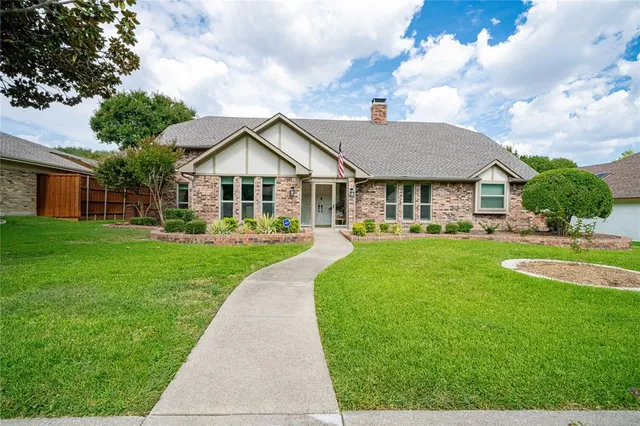 a front view of a house with a yard table and chairs