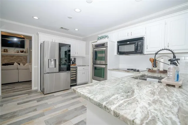a kitchen with a sink microwave and refrigerator