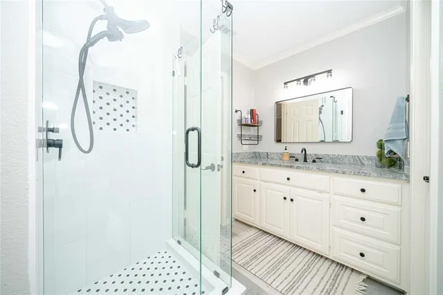 a bathroom with a sink a mirror and shower