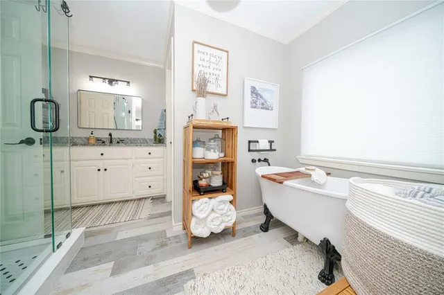 a bathroom with a bathtub sink and mirror