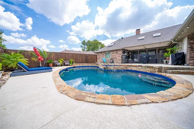 a view of a swimming pool with a patio