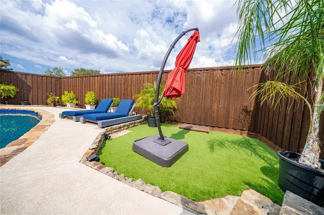 a swimming pool with some trees in the background