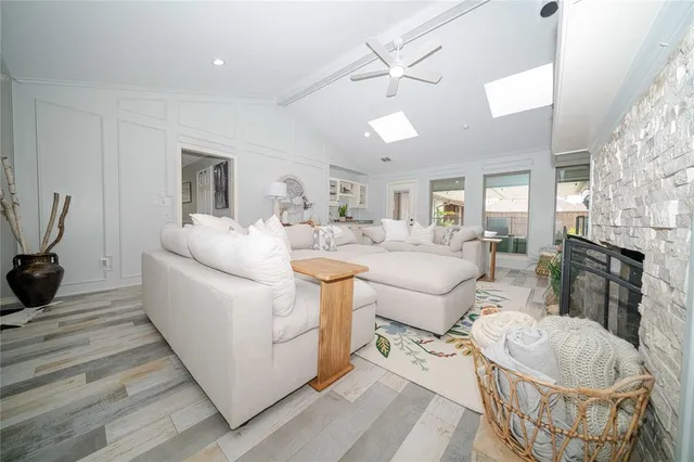 a living room with furniture a fireplace and a flat screen tv