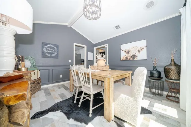 a view of a dining room with furniture and a chandelier