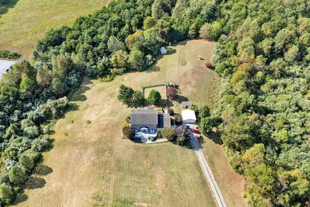 a view of a patio with a table chairs and wooden floor