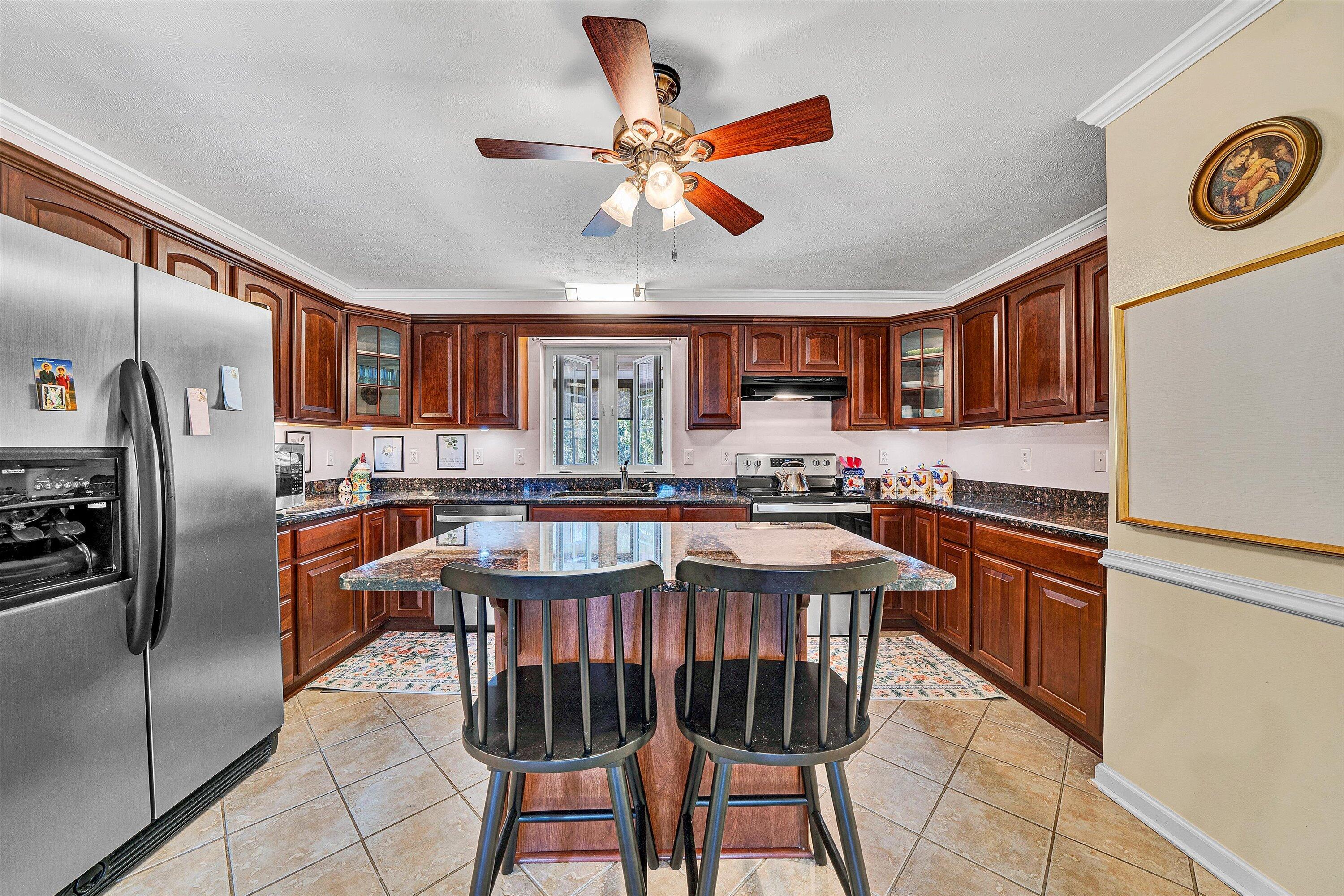 1670 Forge Road Lexington, VA 24450 - Photo 22 of 65 a kitchen with stainless steel appliances granite countertop a refrigerator a stove a sink a dining table and chairs with wooden floor