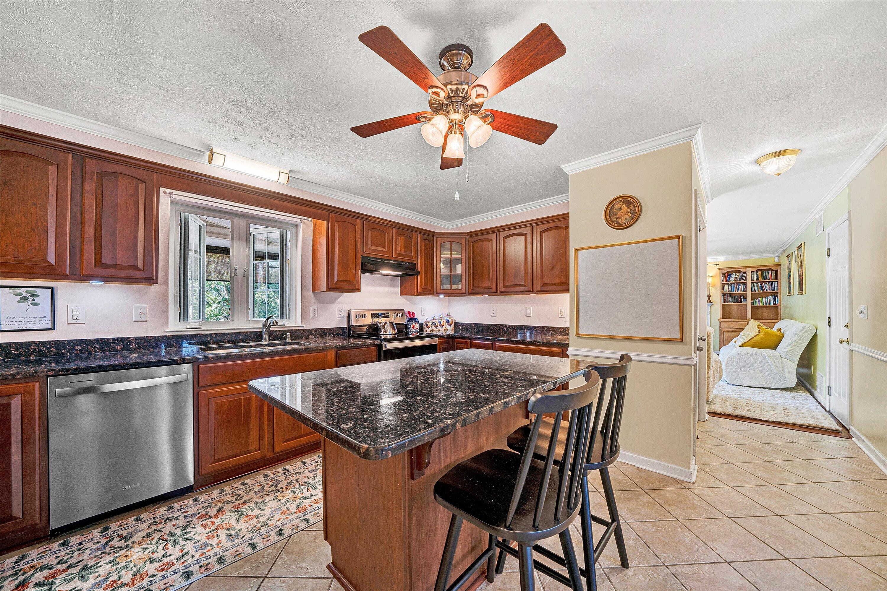 1670 Forge Road Lexington, VA 24450 - Photo 23 of 65 a kitchen with a stove a sink a dining table and chairs