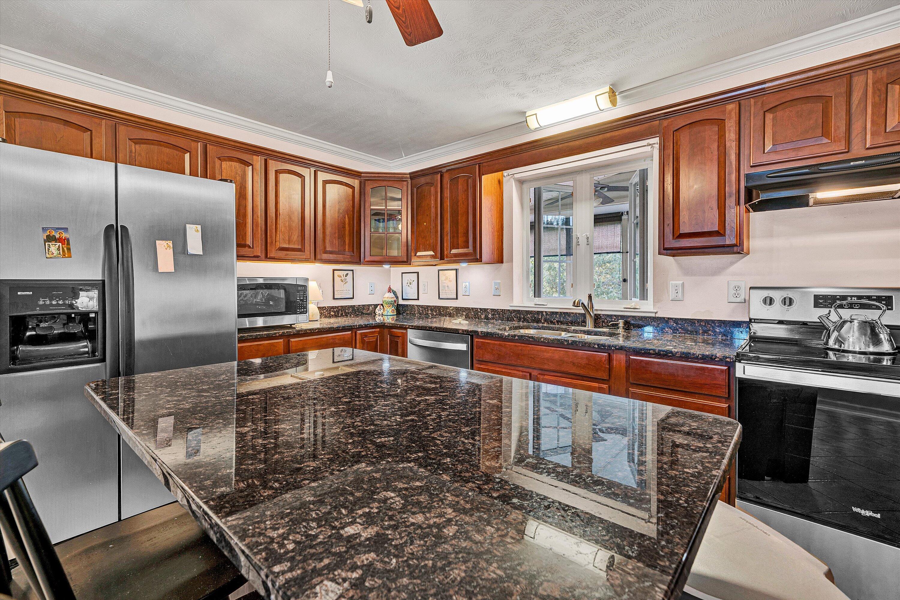 1670 Forge Road Lexington, VA 24450 - Photo 25 of 65 a kitchen with stainless steel appliances granite countertop a stove a sink and a microwave