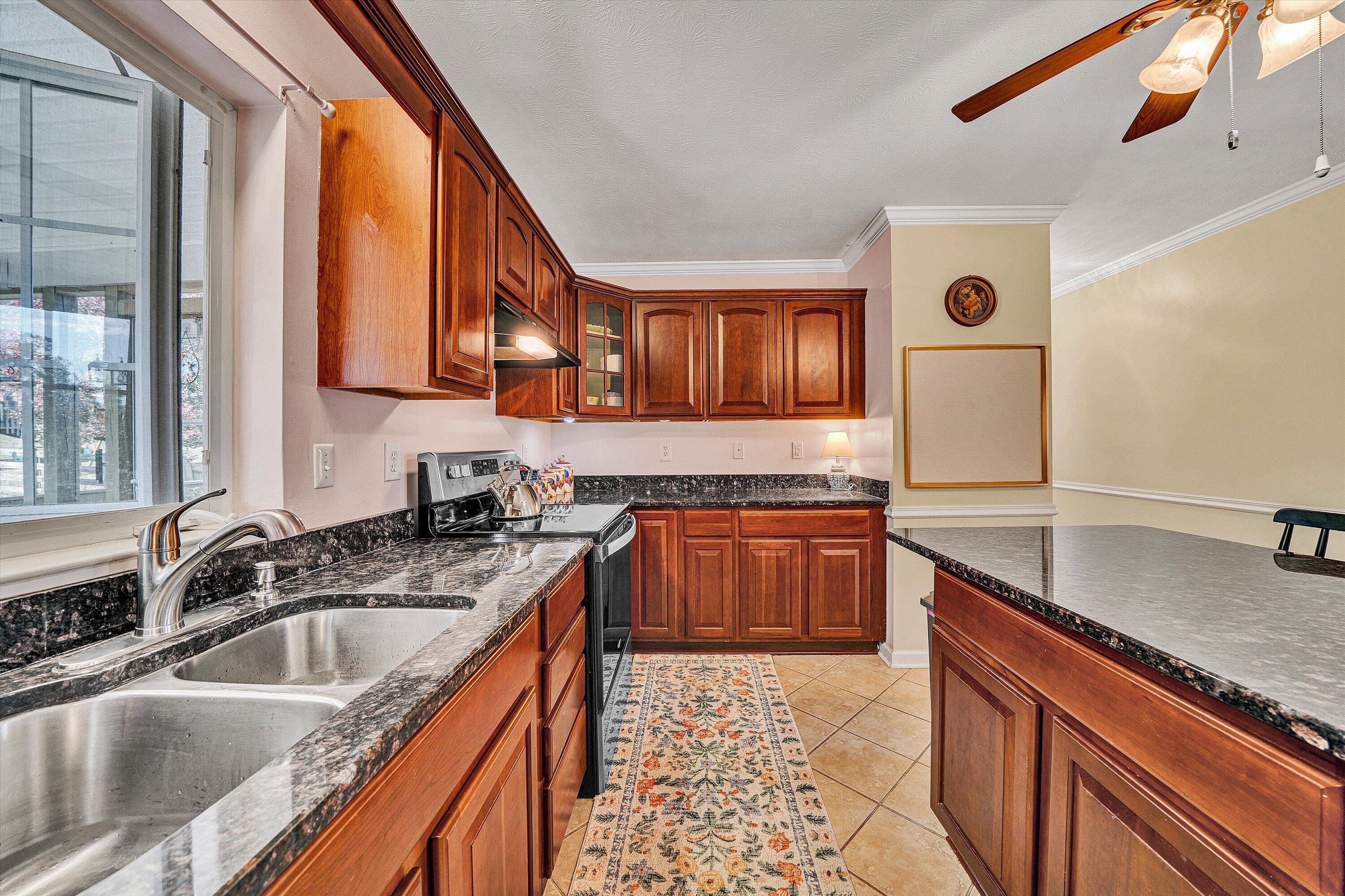 1670 Forge Road Lexington, VA 24450 - Photo 27 of 65 a kitchen with stainless steel appliances granite countertop a sink stove and refrigerator