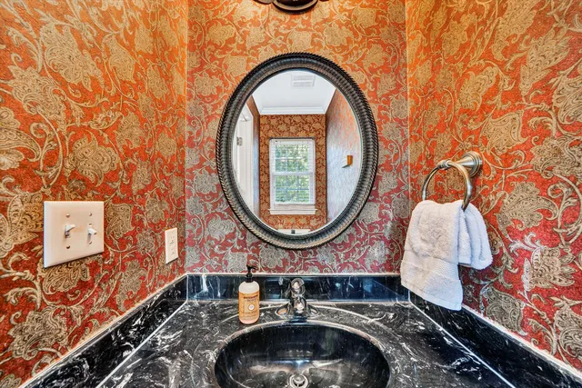 an aerial view of a house with a yard and large trees