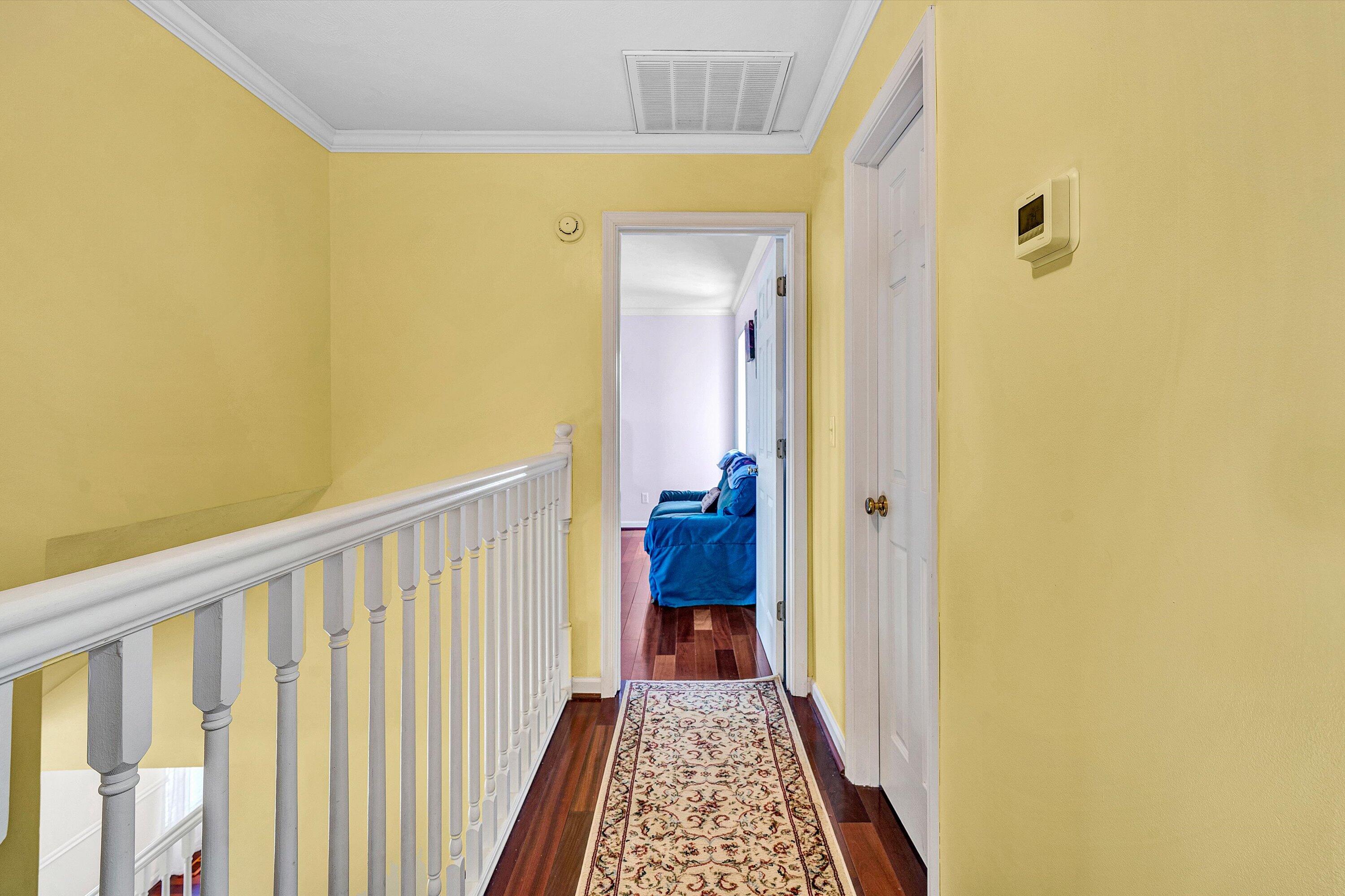 1670 Forge Road Lexington, VA 24450 - Photo 32 of 65 a view of a hallway with wooden floor and a bathroom