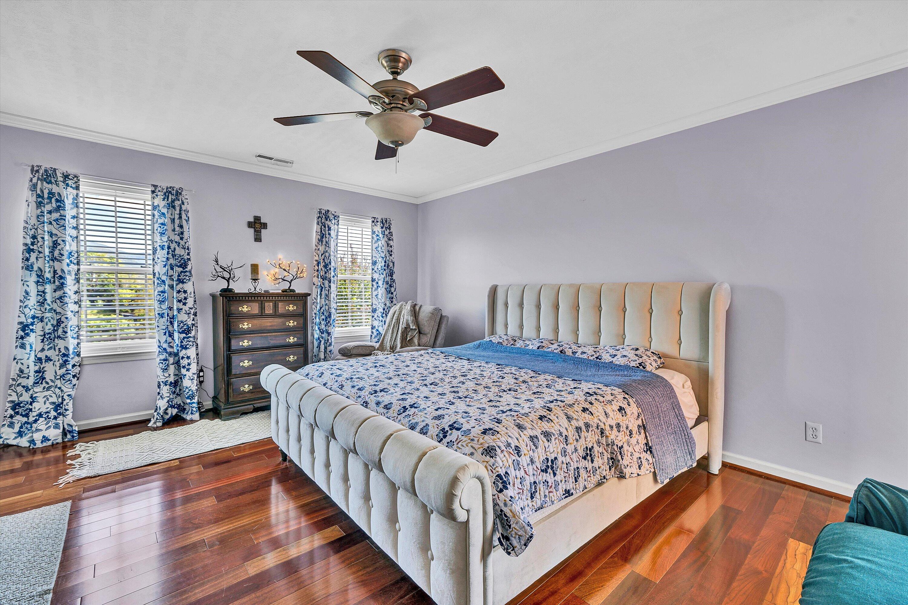 1670 Forge Road Lexington, VA 24450 - Photo 35 of 65 a bedroom with a large bed a chandelier and dresser