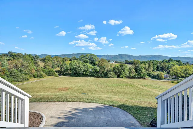 a balcony with wooden floor and outdoor seating