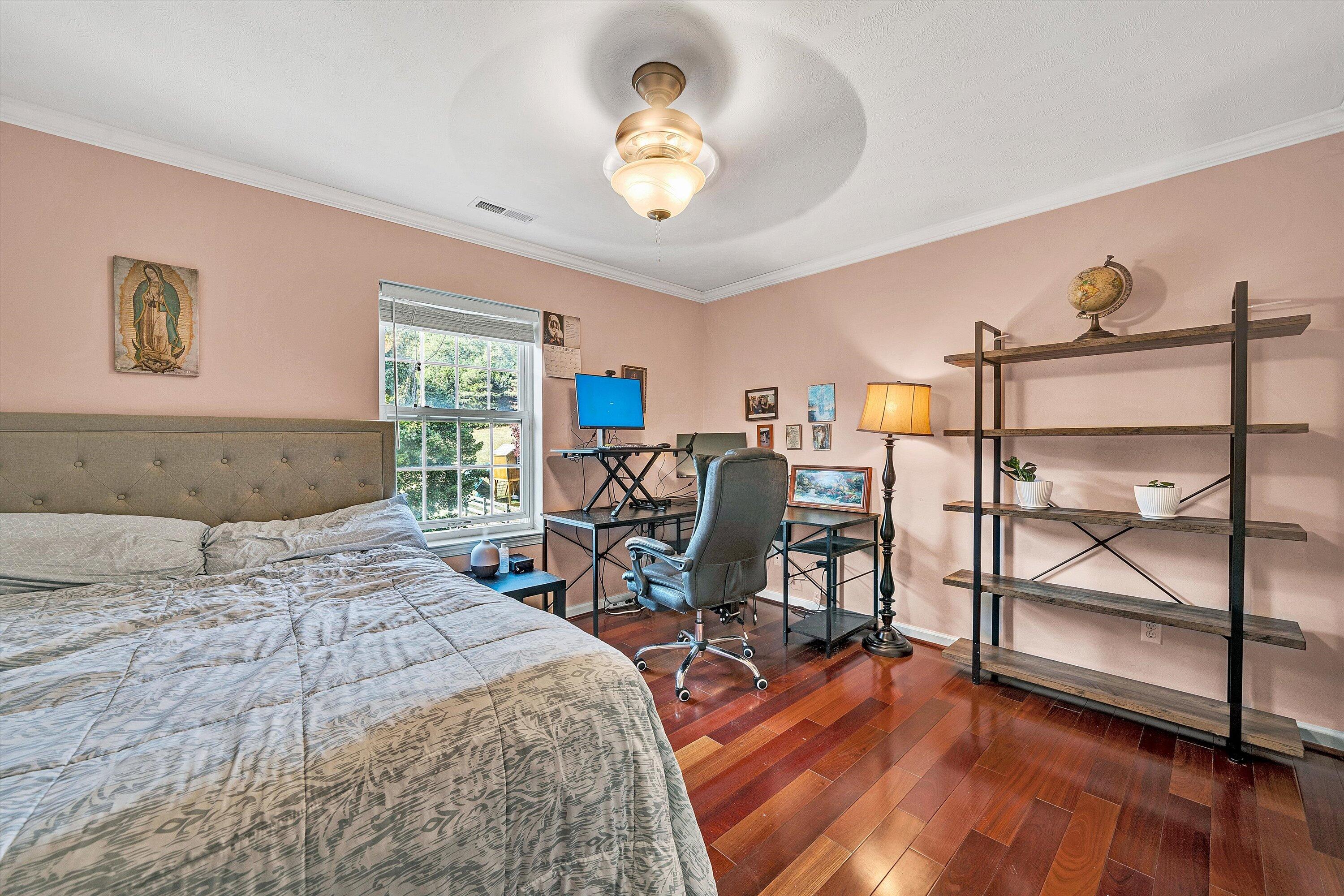1670 Forge Road Lexington, VA 24450 - Photo 42 of 65 a bedroom with a bed a desk and chair with the wooden floor