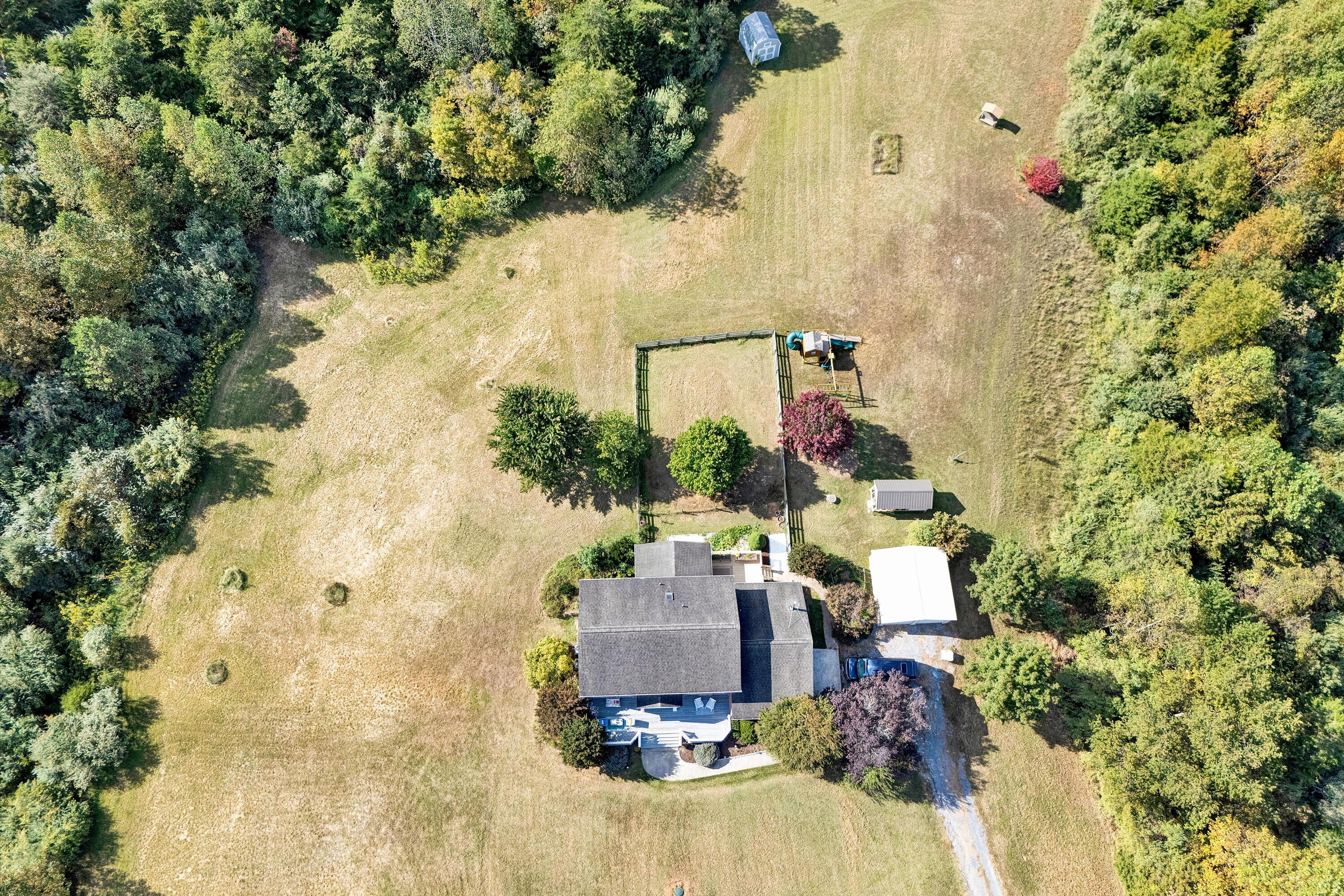 1670 Forge Road Lexington, VA 24450 - Photo 54 of 65 an aerial view of a house with a yard and large trees