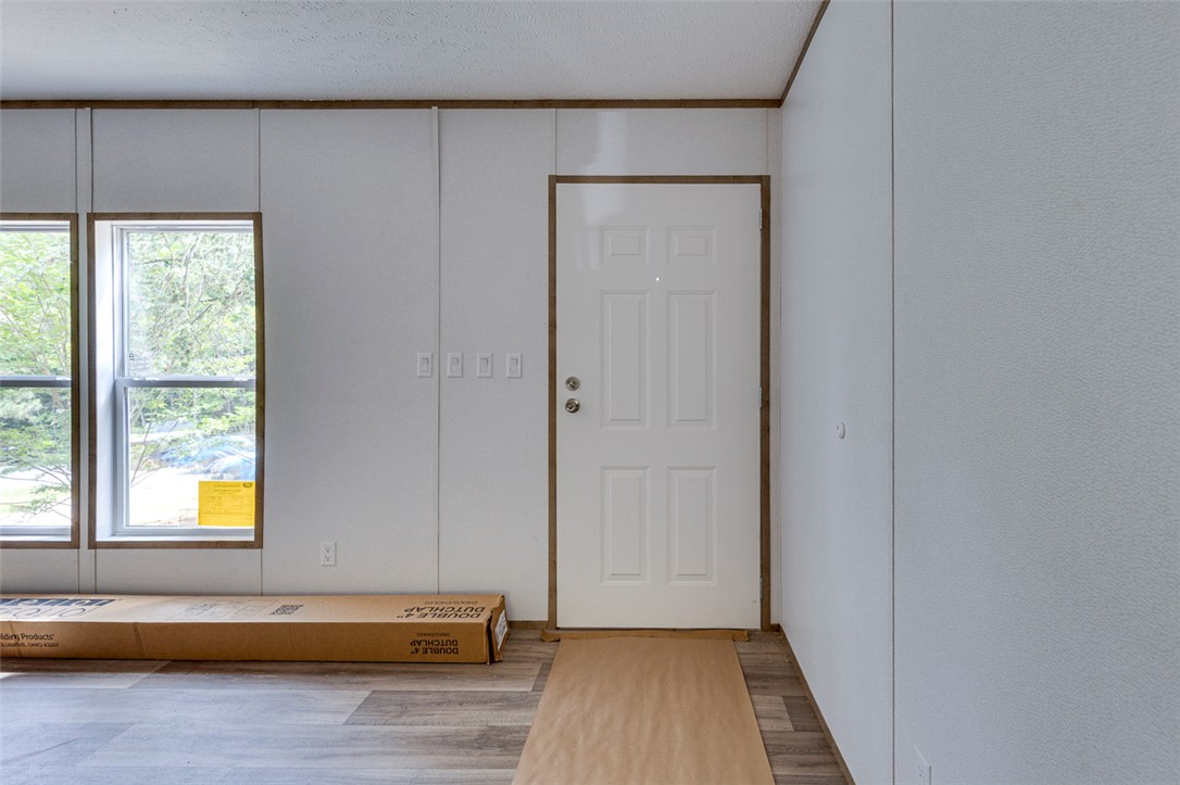 474 Bryant Road Pelzer, SC 29669 - Photo 14 of 42 A well-lit entry with durable flooring provides a welcoming threshold into the home.