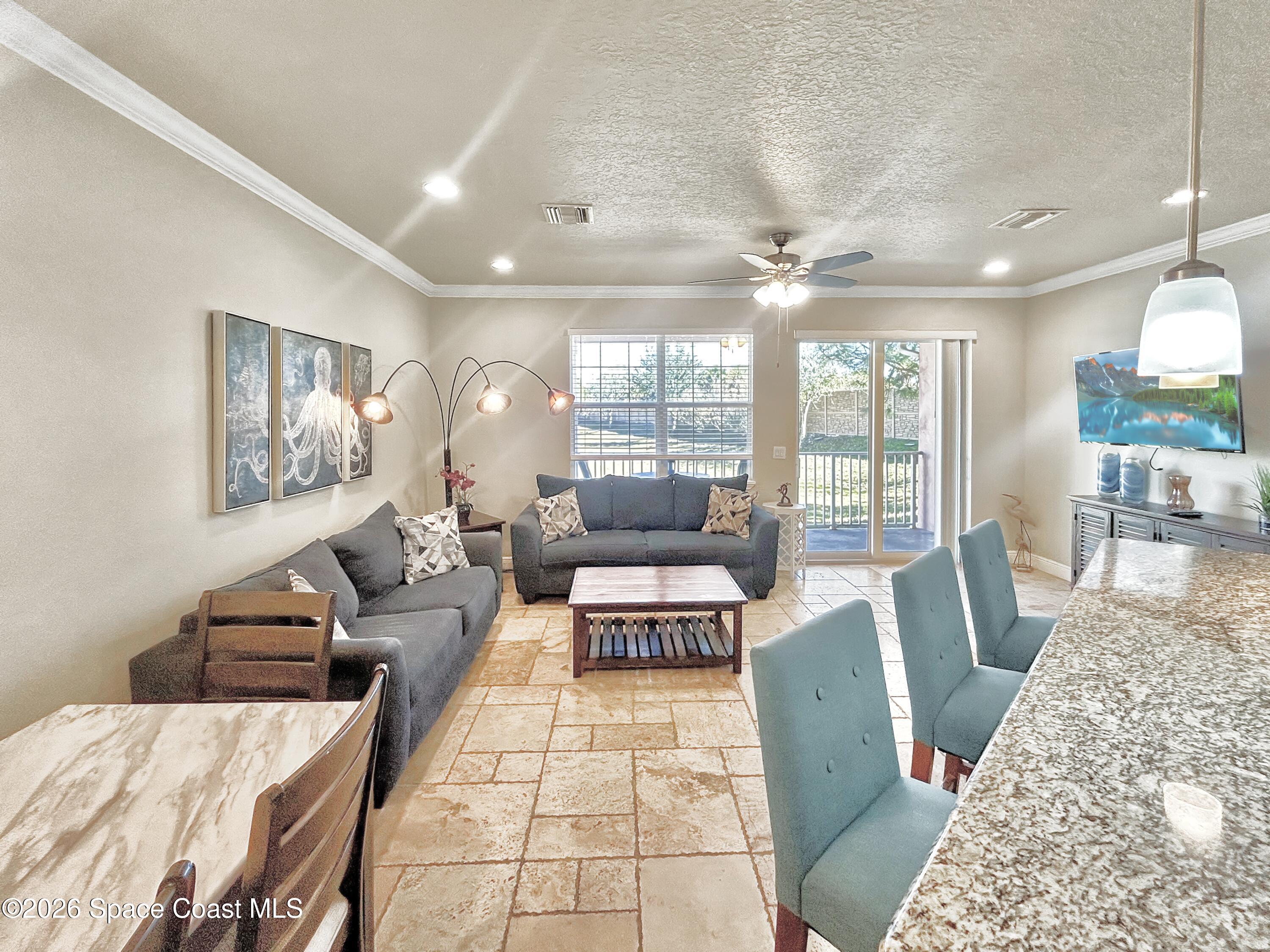 2709 Cutlass Point Lane, Unit 103 Merritt Island, FL 32953 - Photo 5 of 31 a living room with furniture and a rug