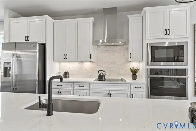 a kitchen with granite countertop a stove and a refrigerator