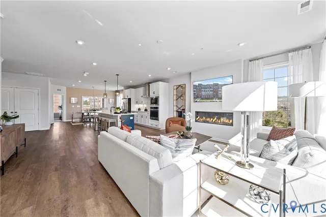 a living room with kitchen island furniture and a table