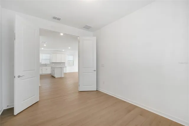 a kitchen with a refrigerator sink and cabinets