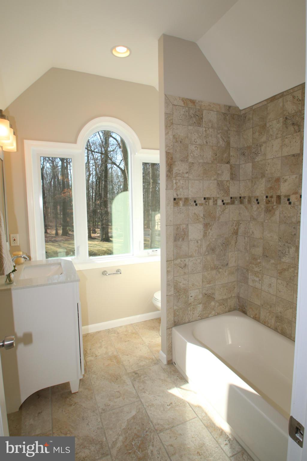 4321 Oaktree Road Rockville, MD 20853 - Photo 13 of 24 a bathroom with a bathtub and a shower