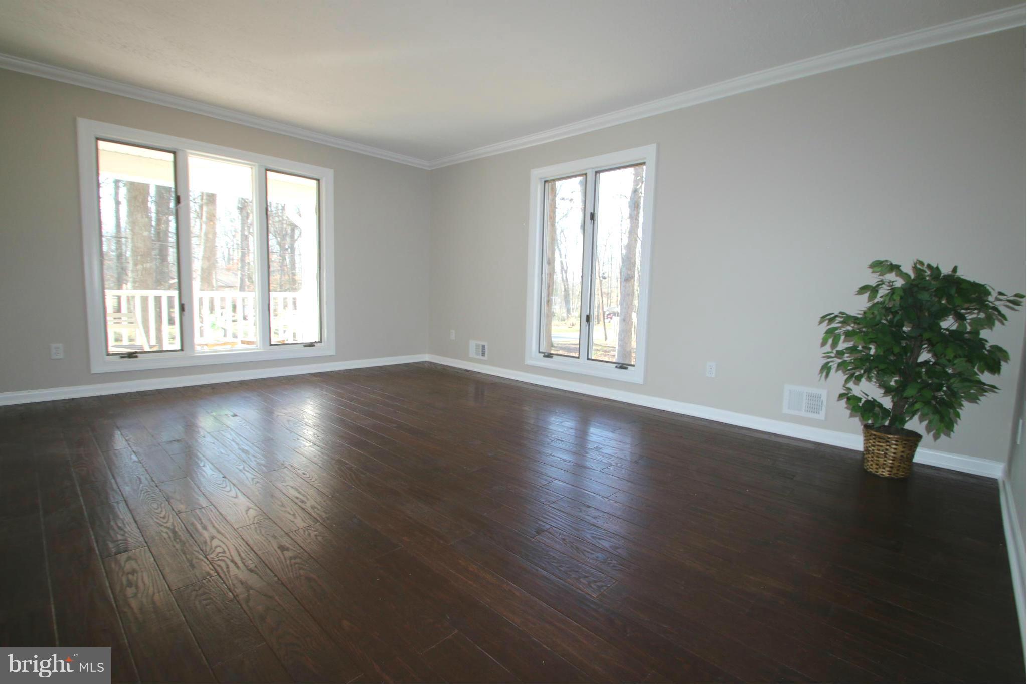4321 Oaktree Road Rockville, MD 20853 - Photo 8 of 24 a view of an empty room with wooden floor and a window