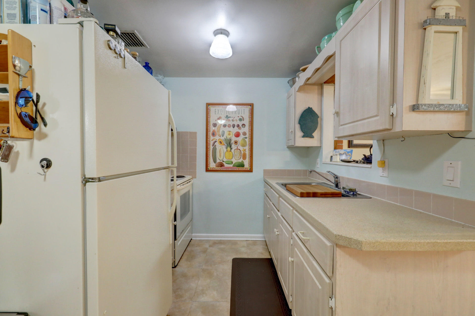 5806 Keith Road Jupiter, FL 33458 - Photo 13 of 24 a kitchen with stainless steel appliances granite countertop a refrigerator and a sink