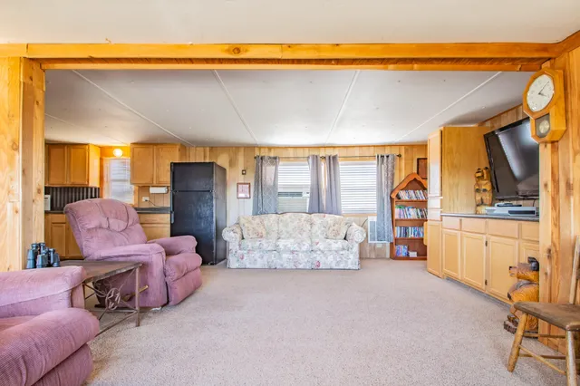 a bedroom with furniture and a large window