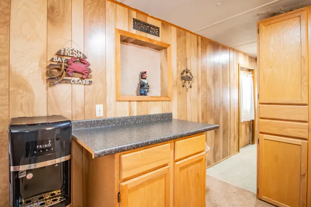 a kitchen with stainless steel appliances granite countertop a sink and a refrigerator