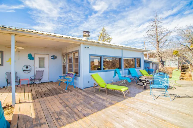 a view of a house with swimming pool and sitting area