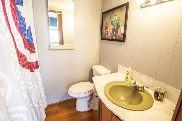 a white toilet sitting next to a bathroom sink