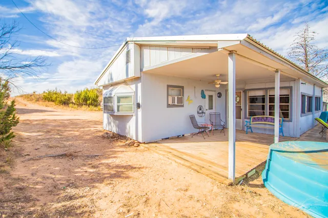 a view of a house with a backyard and swimming pool