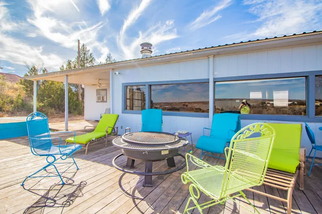 a view of a swimming pool with a dining table and chairs