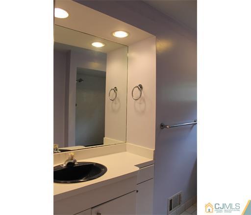 21 Chandler Road Edison, NJ 08820 - Photo 13 of 20 a bathroom with a sink and a mirror