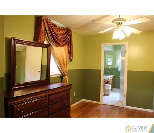 21 Chandler Road Edison, NJ 08820 - Photo 18 of 20 a bathroom with a sink a mirror and a shower