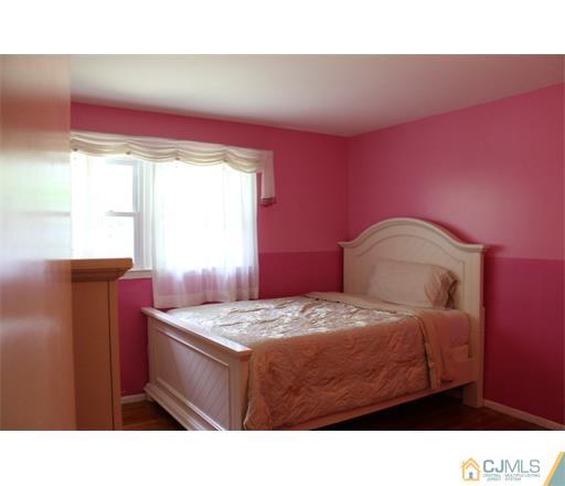 21 Chandler Road Edison, NJ 08820 - Photo 19 of 20 a bedroom with a bed and window