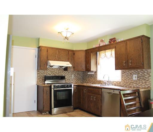 21 Chandler Road Edison, NJ 08820 - Photo 3 of 20 a kitchen with stainless steel appliances granite countertop a stove a sink and a refrigerator