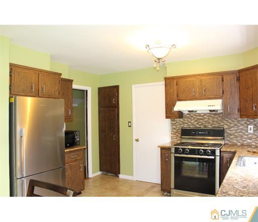 21 Chandler Road Edison, NJ 08820 - Photo 6 of 20 a kitchen with a refrigerator and a stove top oven