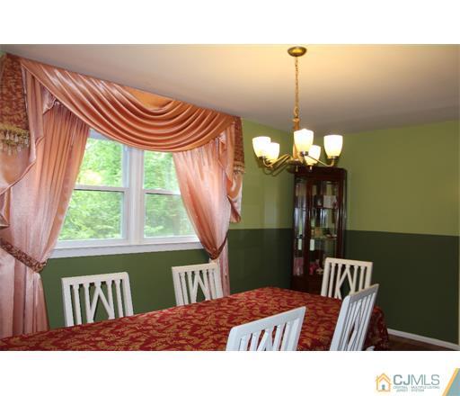 21 Chandler Road Edison, NJ 08820 - Photo 10 of 20 a bedroom with a bed and a chandelier